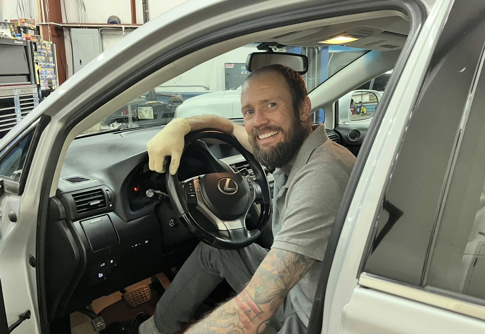 Technician at Action Automotive Colorado Springs smiling in a customer's car