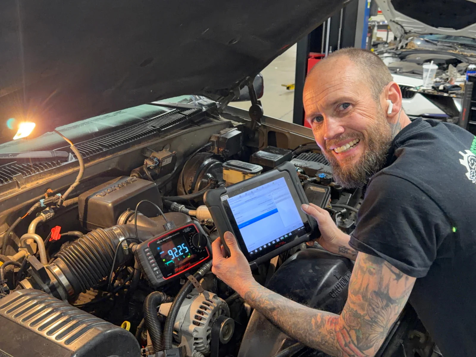 Griff using diagnostic equipment to test a vehicle's electrical system in Colorado Springs